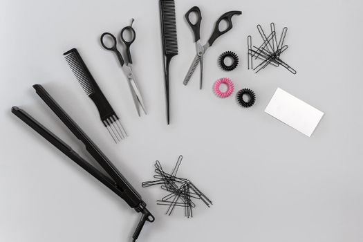 Hairdresser set with various accessories on gray background. Top view. Still life. Flat lay.