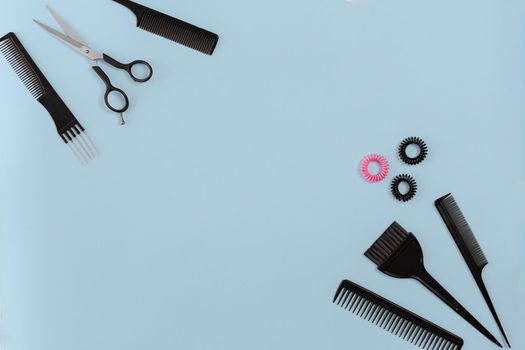 Hairdresser set with various accessories on gray background. Top view. Copy space. Still life. Mock-up. Flat lay