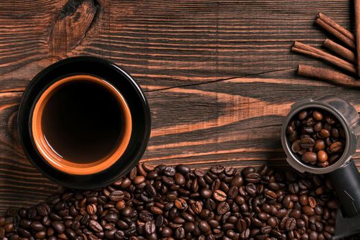 Coffee cup and beans frame on wooden table. Top view. Copy space. Still life. Mock-up. Flat lay