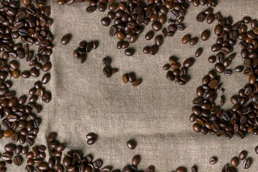 Coffee beans on burlap background. Top view. Copy space. Still life. Mock-up. Flat lay