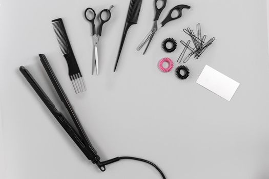 Hairdresser set with various accessories on gray background. Top view. Still life. Flat lay.