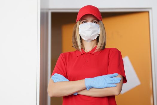 Portrait of woman in red uniform wear protective face mask and gloves, importance of wearing protection in virus times. Prevention of covid spread concept