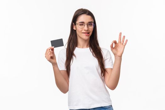 Got everything under control. Good-looking carefree, calm woman assure you all good, no problem cause she have credit card, wink and bite lip encourage all ok, white background.