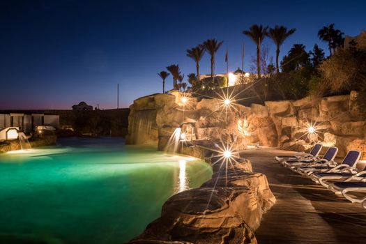 Long exposure shot of a swimming pool at luxury night illumination on a beautiful resort in Egypt