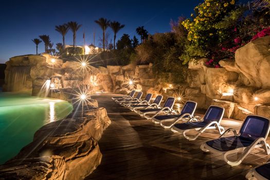 Evening view for luxury swimming pool in night illumination on a beautiful resort in Egypt