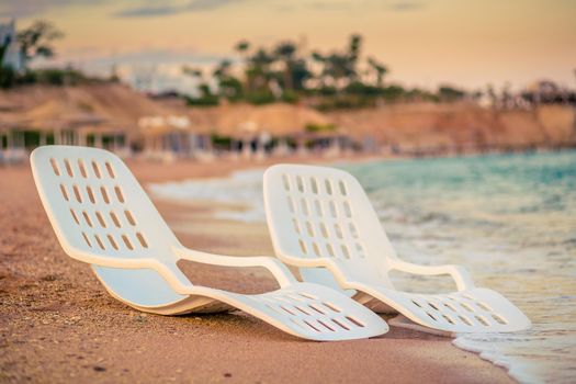 Landscape of Two Lonely beachchairs near the sea in the morning at a perfect beach in Egypt