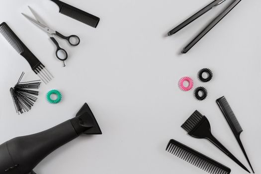 Hairdresser set with various accessories on gray background. Top view. Still life. Flat lay. Copy space
