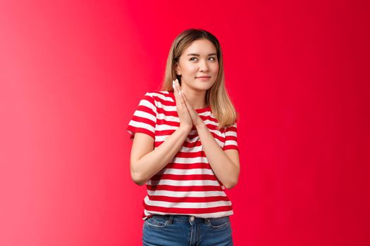 Smart and creative good-looking blond asian girl rubbing palms together devious and cunning have perfect plan, woman smirking curiously look up scheming have idea, stand red background.