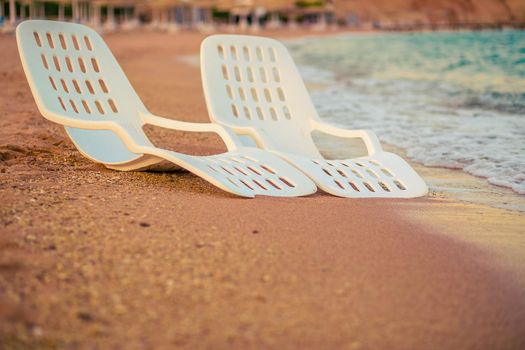 Landscape of Two Lonely beachchairs near the sea in the morning at a perfect beach in Egypt