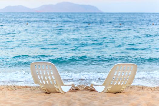 Landscape of Two Lonely beachchairs near the sea in the morning at a perfect beach in Egypt