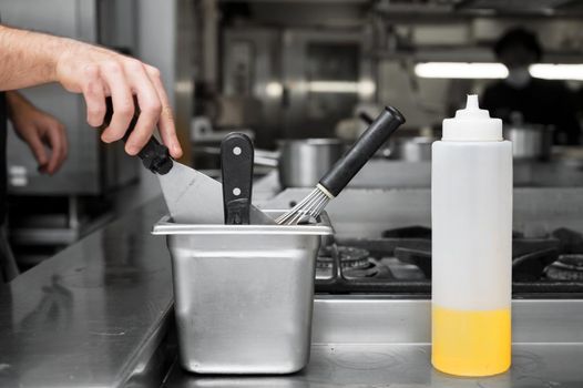 Close up of a chef using a spatula at a commercial kitchen. High quality photo