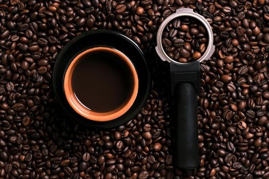 A cup of black coffee with coffee bean as background. Top view. Copy space. Still life. Mock-up. Flat lay