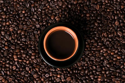 Coffee cup on coffee beans background. Top view. Still life. Copy space. Flat lay.
