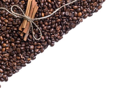 Grains of coffee and cinnamon on a white background. Top view. Still life. Copy space. Flat lay.