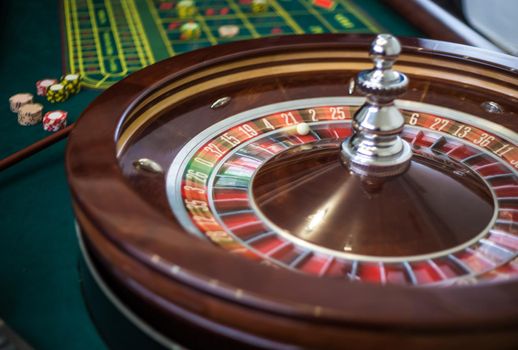 Classic casino roulette wheel with red sector twenty-one 21 and white ball. Close up details