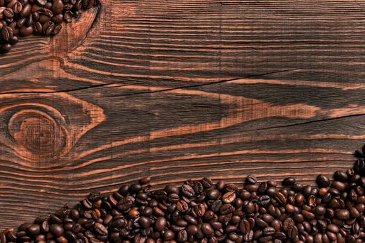 Coffee beans on wooden table texture with copy space. View from above. Still life. Flat lay. Mock-up