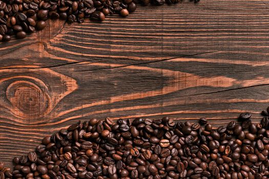 Coffee beans on wooden table texture with copy space. View from above. Still life. Flat lay. Mock-up