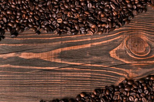 Coffee beans on wooden background. Top view. Still life. Copy space. Flat lay.