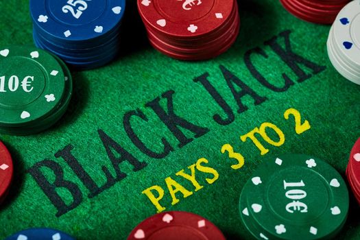 Black Jack gambling table with casino chips, close-up. Casino, gambling, poker, and entertainment concept