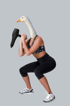 Beauty atletic woman in sport clothes with goose head. Sports concept on the theme of comics and сontemporary art collage.