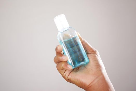 close up of young man hand using sanitizer gel for preventing virus.