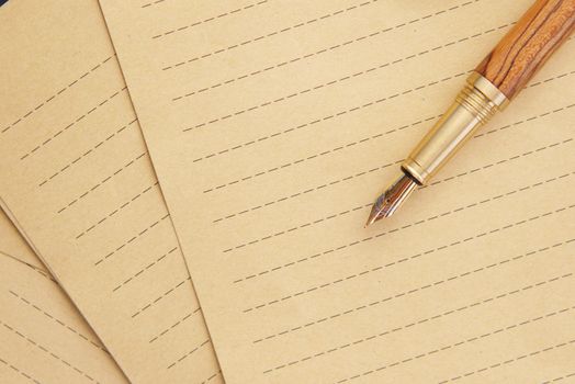 old empty paper and fountain pen on table .