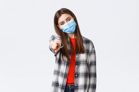 Coronavirus outbreak, leisure on quarantine, social distancing and emotions concept. Young determined girl making choice, pointing finger at camera, need you, wear medical mask. ask join team.