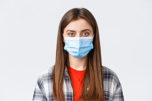 Coronavirus outbreak, leisure on quarantine, social distancing and emotions concept. Close-up of young female student, girl in medical mask looking at camera, normal expression.