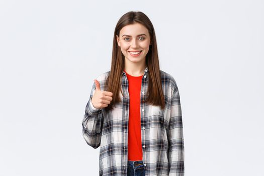 Lifestyle, different emotions, leisure activities concept. Confident happy smiling female student found great job, advice website or company service, thumb-up in approval, recommend or guarantee.