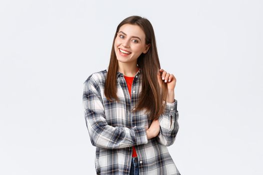 Lifestyle, different emotions, leisure activities concept. Enthusiastic and intrigued attractive girl looking with interest, picking products in store, smiling and touching haircut, casual outfit.