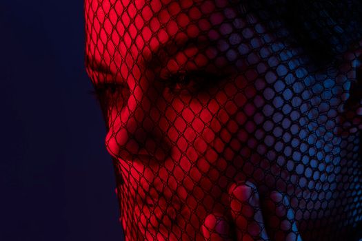 attractive woman posing mesh on the face neon Lifestyle unaltered. High quality photo