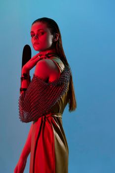 photo pretty woman Glamor posing red light metal armor on hand unaltered. High quality photo