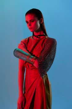 beautiful woman Glamor posing red light metal armor on hand Lifestyle unaltered. High quality photo