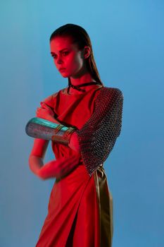 young woman Glamor posing red light metal armor on hand Lifestyle unaltered. High quality photo