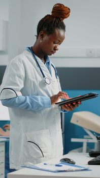 Woman doctor holding digital tablet with touch screen for healthcare appointments. Medic working with modern device with technology and medical equipment for checkup visits with patients