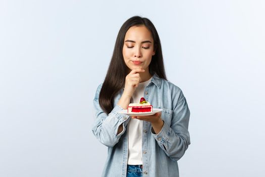 Social distancing lifestyle, covid-19 pandemic, celebrating holidays during coronavirus concept. Thoughtful serious-looking b-day girl thinking focused what wish make on birthday.