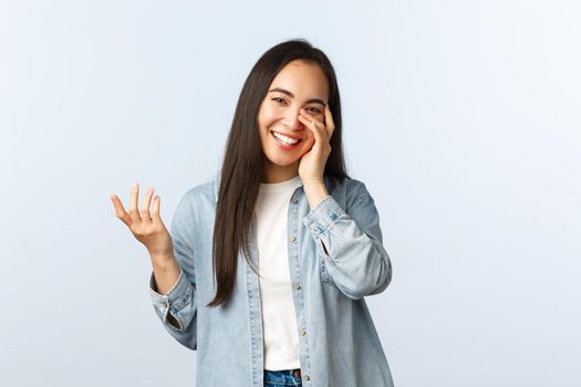 Lifestyle, people emotions and beauty concept. Carefree pretty female asian in casual clothes, laughing touch face delighted, being pleased chuckle over funny joke.