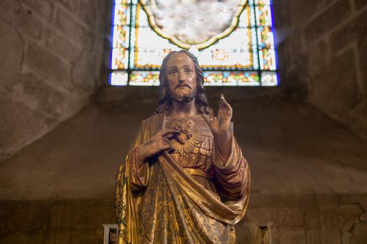 Statue of Jesus with a red heart in a church