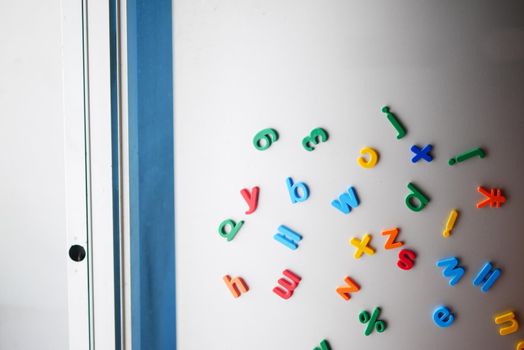 colorful plastic letters on a fridge .