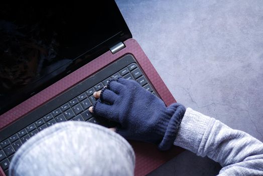 hacker hand stealing data from laptop top down.