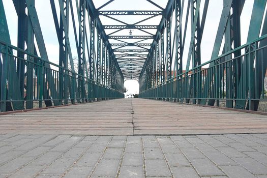 Old metal overpass, bridge over the river. Rivet metal bridge in town. Breclav, Czechia.