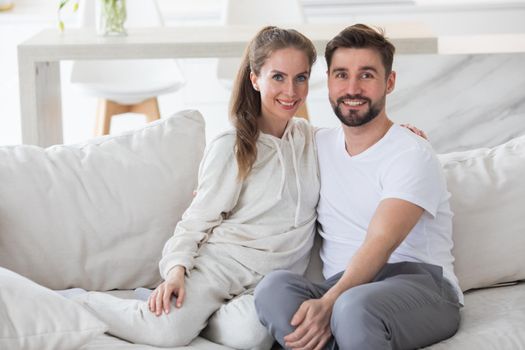 Couple relaxing in living room and smiling