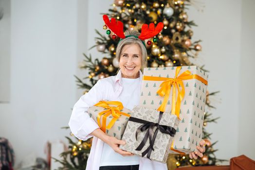 Grandma wearing deer christmas hat, happy smiling face.