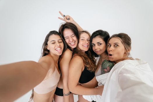 Diverse models wearing comfortable underwear take selfie, look at camera having smile and natural unique beauty