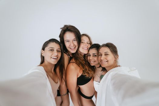 Diverse models wearing comfortable underwear take selfie, look at camera having smile and natural unique beauty