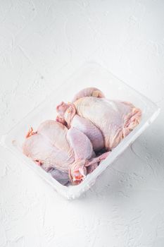 Raw chicken in plastic sealed plastic box, on white background with copy space for text