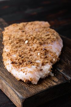 Crispy garlicky chicken raw ingredient, on wooden table