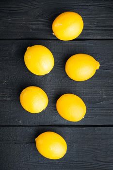 Fresh lemons set, on black wooden table background, top view flat lay