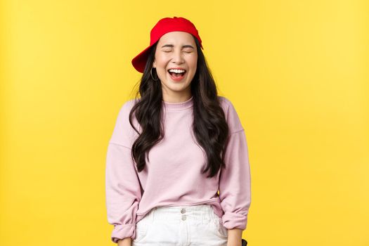 People emotions, lifestyle leisure and beauty concept. Happy carefree attractive asian woman having fun, enjoying summer vacation, laughing with closed eyes and amused expression.