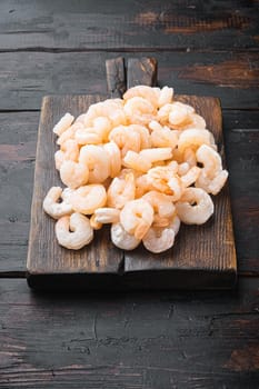 Boiled Peeled Shrimps, Prawns set, on wooden serving board, on old dark wooden table